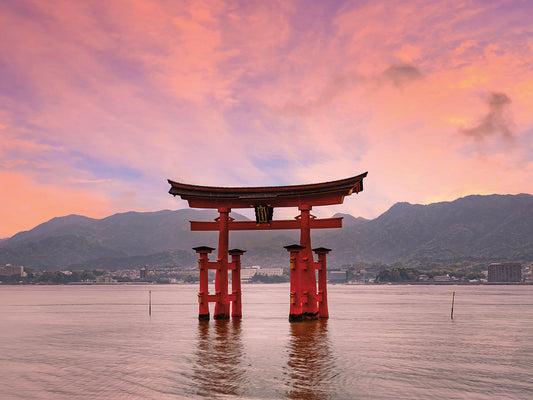 Vermilion Torii of Itsukushima Shrine on Miyajima at sunset