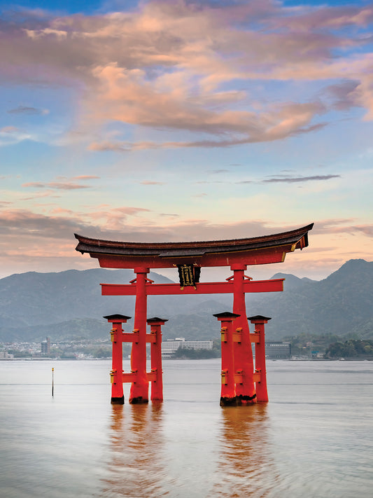 Vermilion Torii of Itsukushima Shrine on Miyajima in the evening